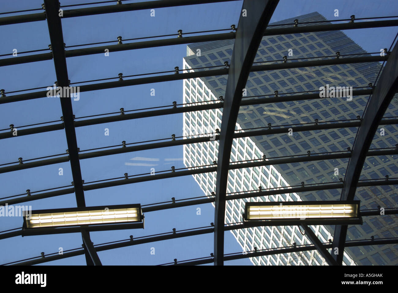 Canary Wharf London roof of Tube station and view through glass to 40 Bank Street Stock Photo