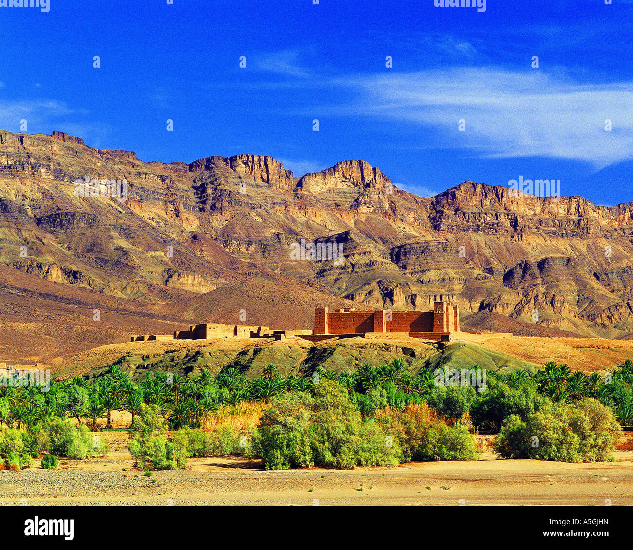 Hilltop casbah (fortified village) in the valley of the River Draa, Morocco Stock Photo