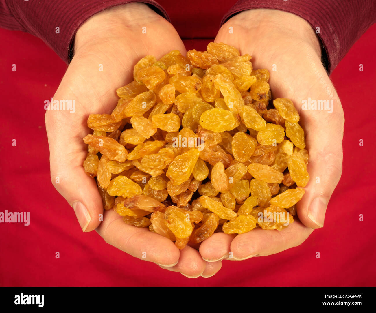 MAN HOLDING GOLDEN RAISINS Stock Photo - Alamy