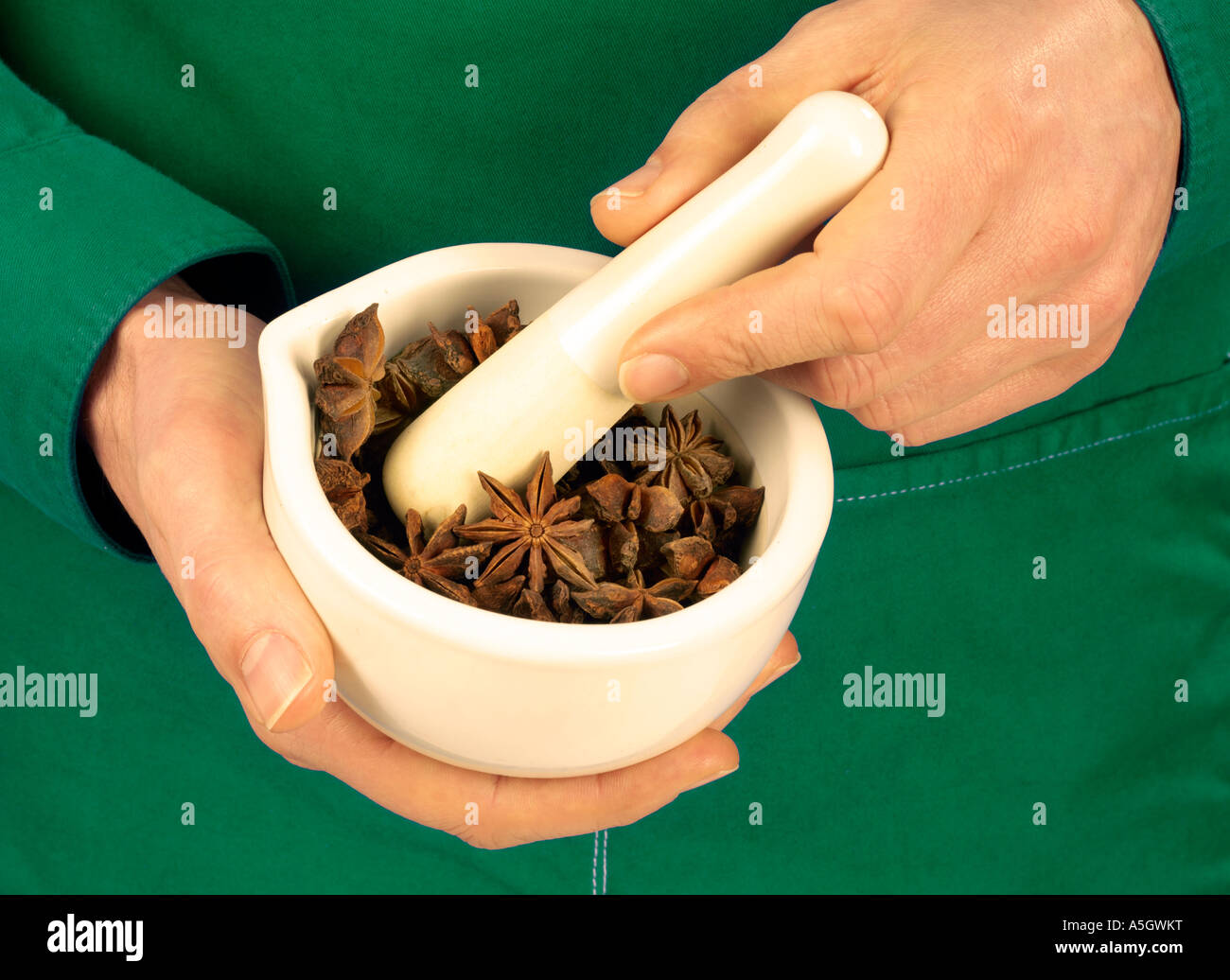MAN GRINDING STAR ANISE Stock Photo Alamy