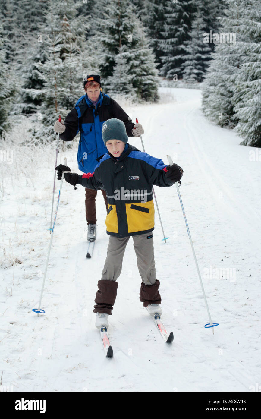 a little boy and his mother cross country skiing in the Harz Mountains