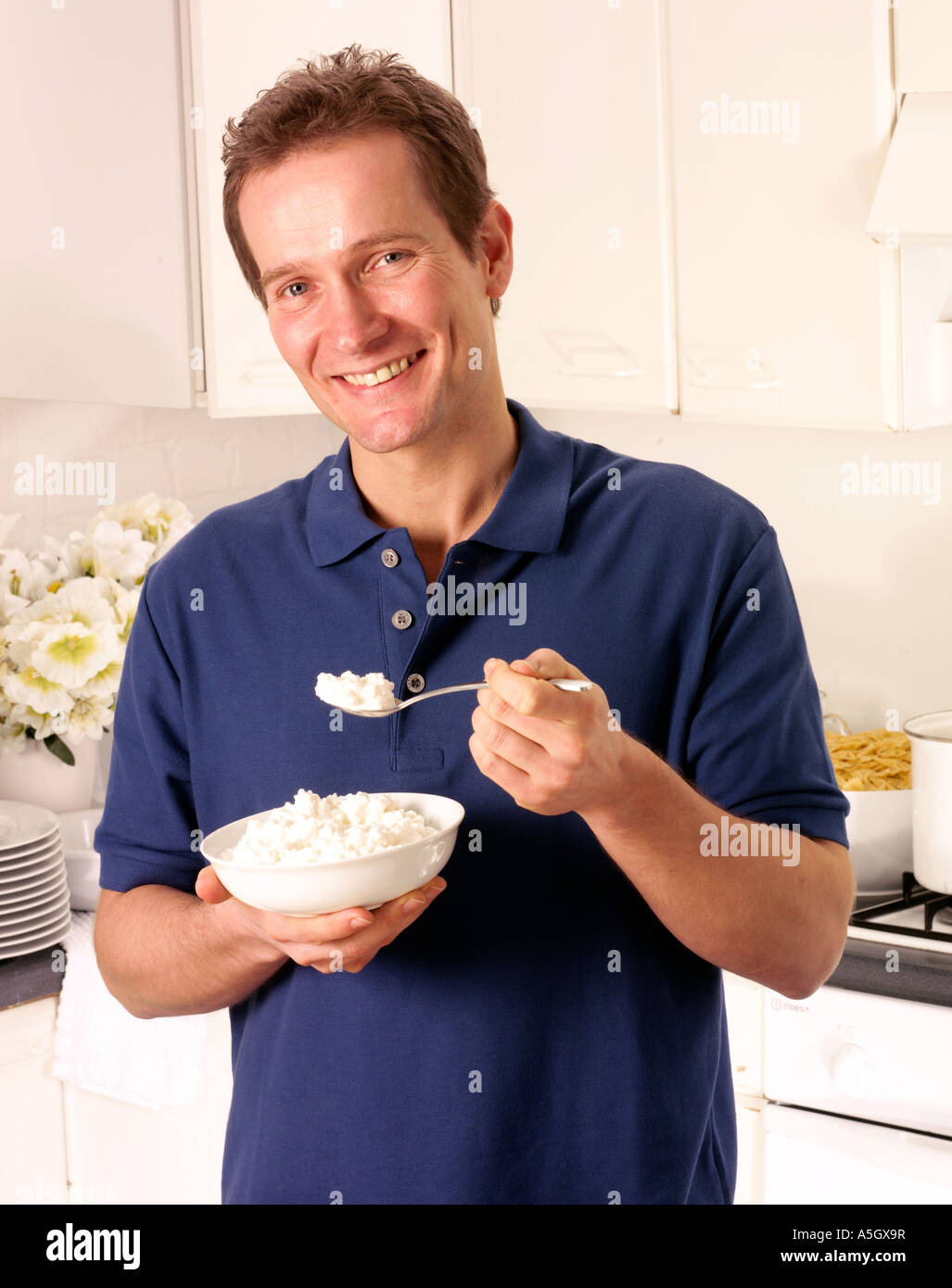 Man In Kitchen Eating Cottage Cheese Stock Photo 11310994 Alamy