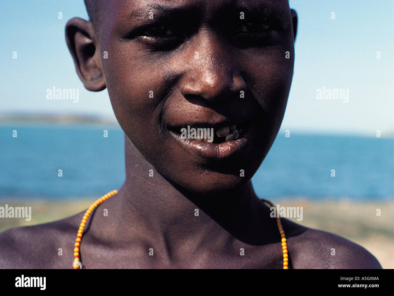 El Molo boy with teeth stained brown by excess minerals and fluoride in the water El Molo Bay Lake Turkana Kenya Stock Photo