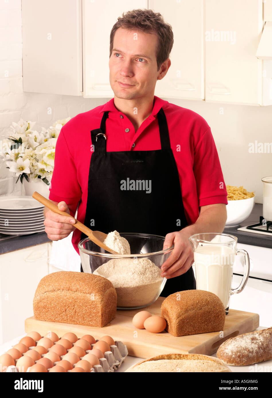 MAN BAKING IN KITCHEN Stock Photo