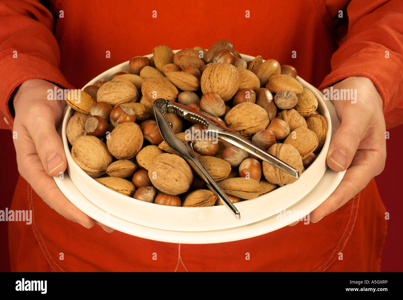 MAN HOLDING BOWL OF MIXED NUTS Stock Photo Alamy