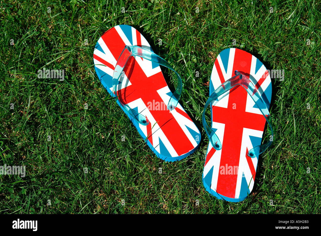 union jack flip flops on grass Stock 