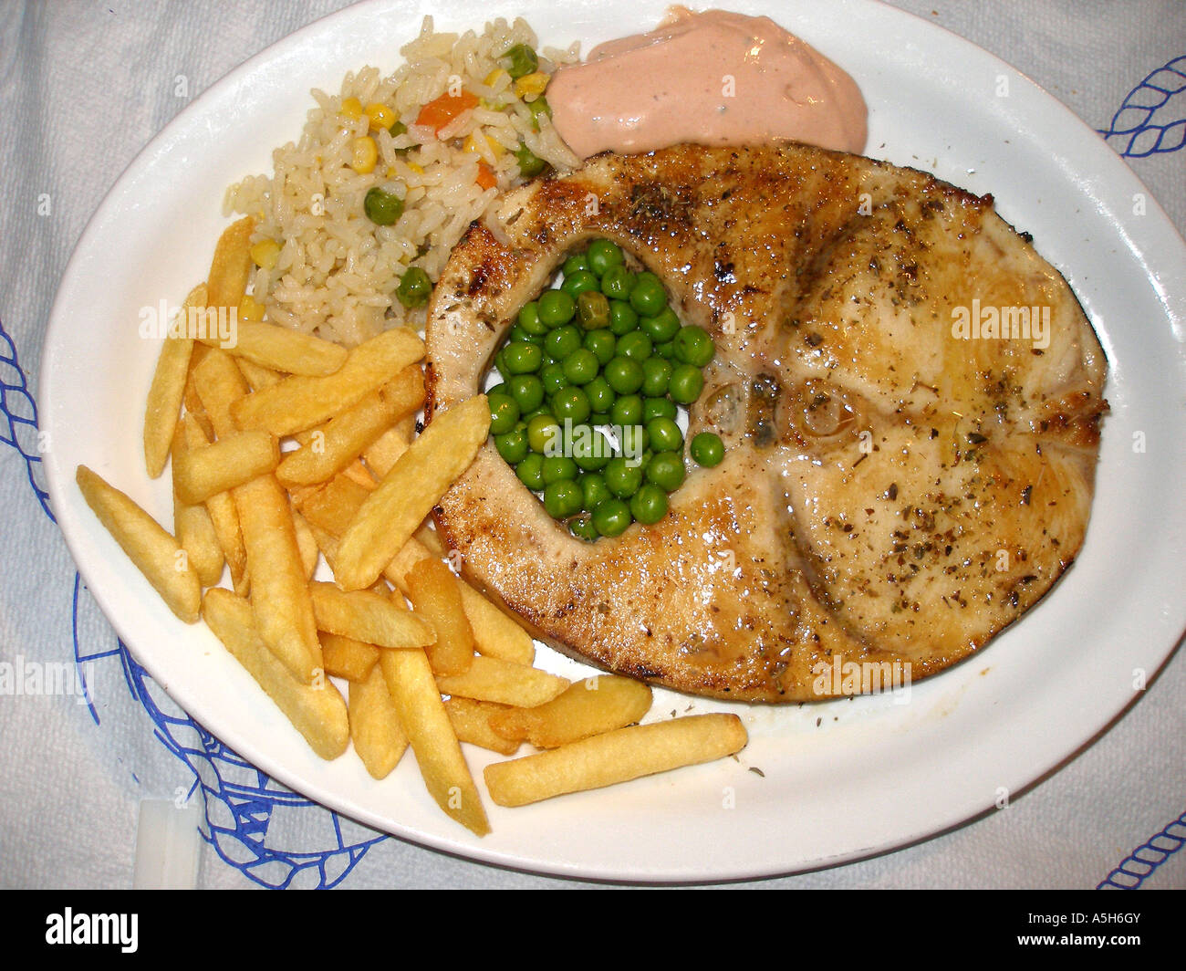 Greek dish, grilled Swordfish with chips, peas, rice and taramasalata