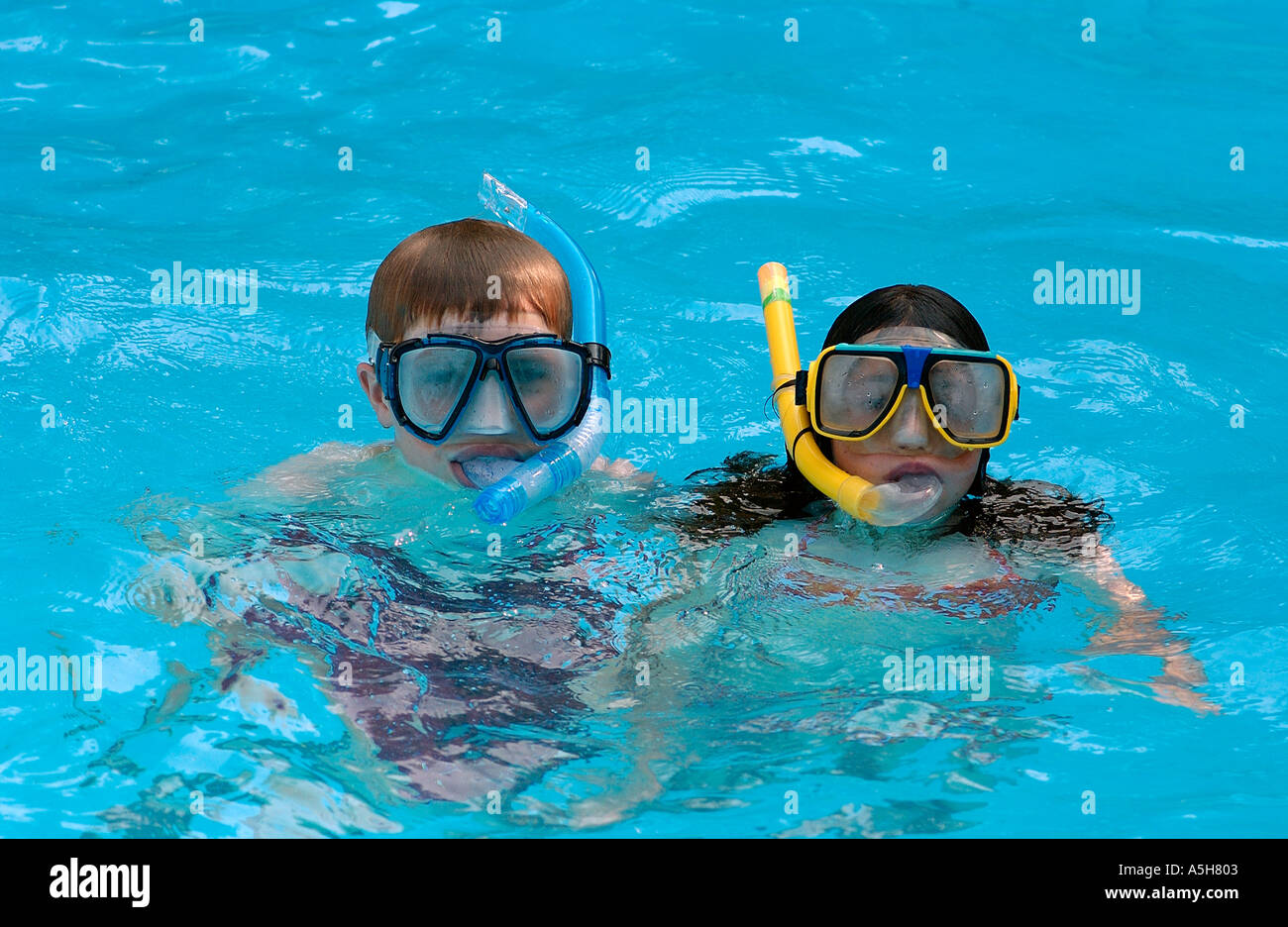 two children wearing snorkels in the water Stock Photo Alamy