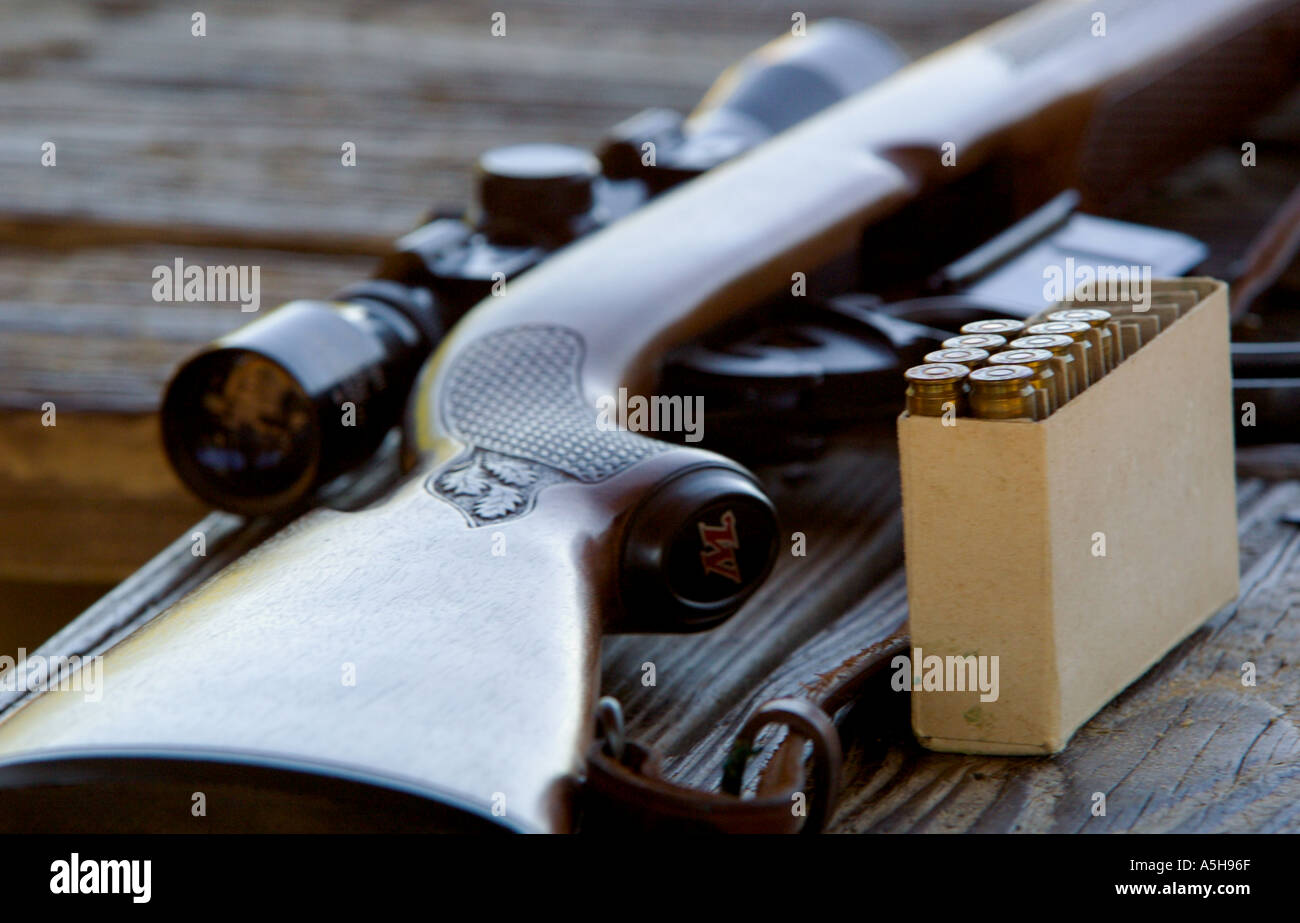 Winchester 308 caliber hunting rifle with box of ammunition at rifle