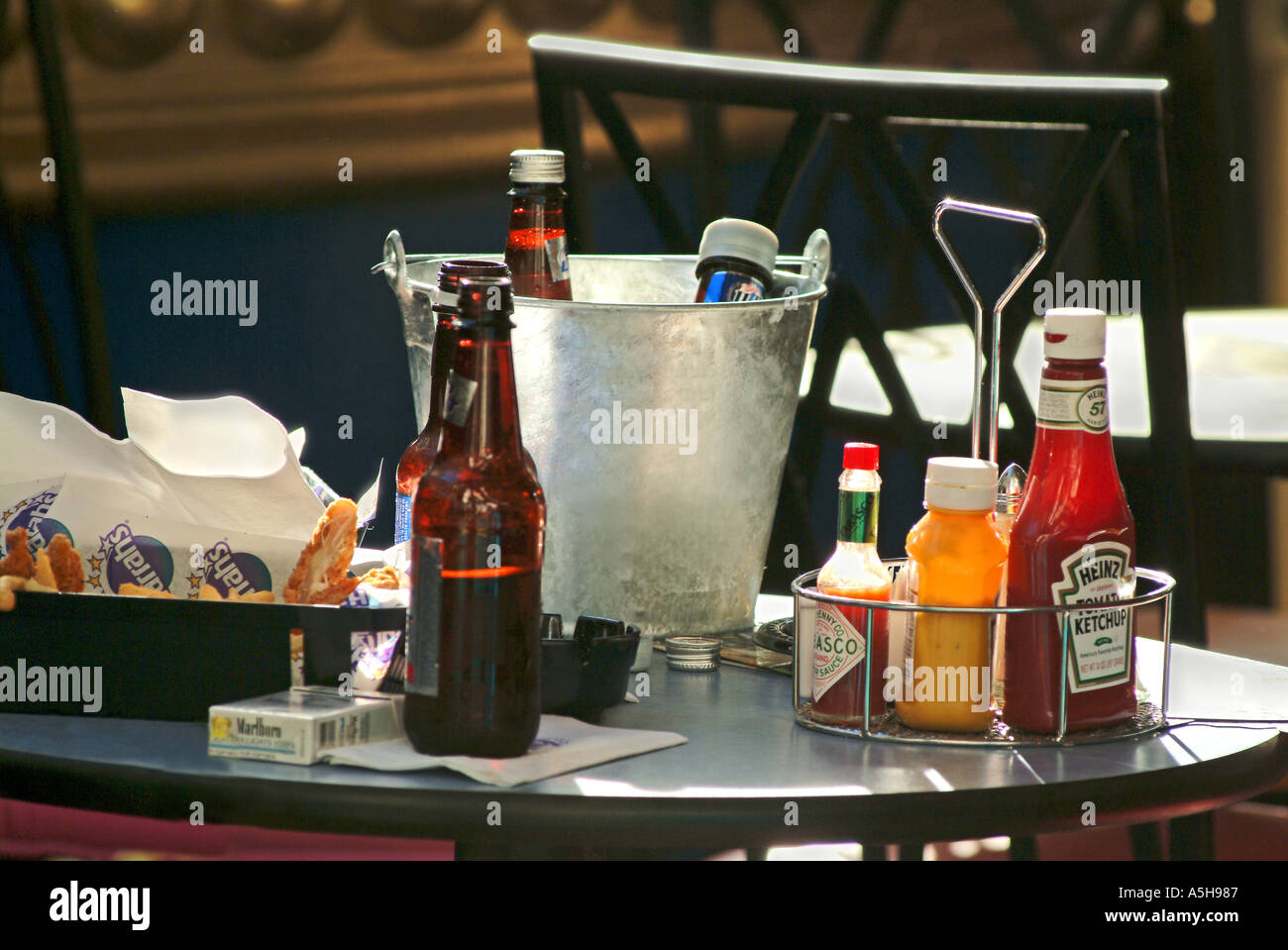 Outdoor restaurant table with condiments and food Stock Photo