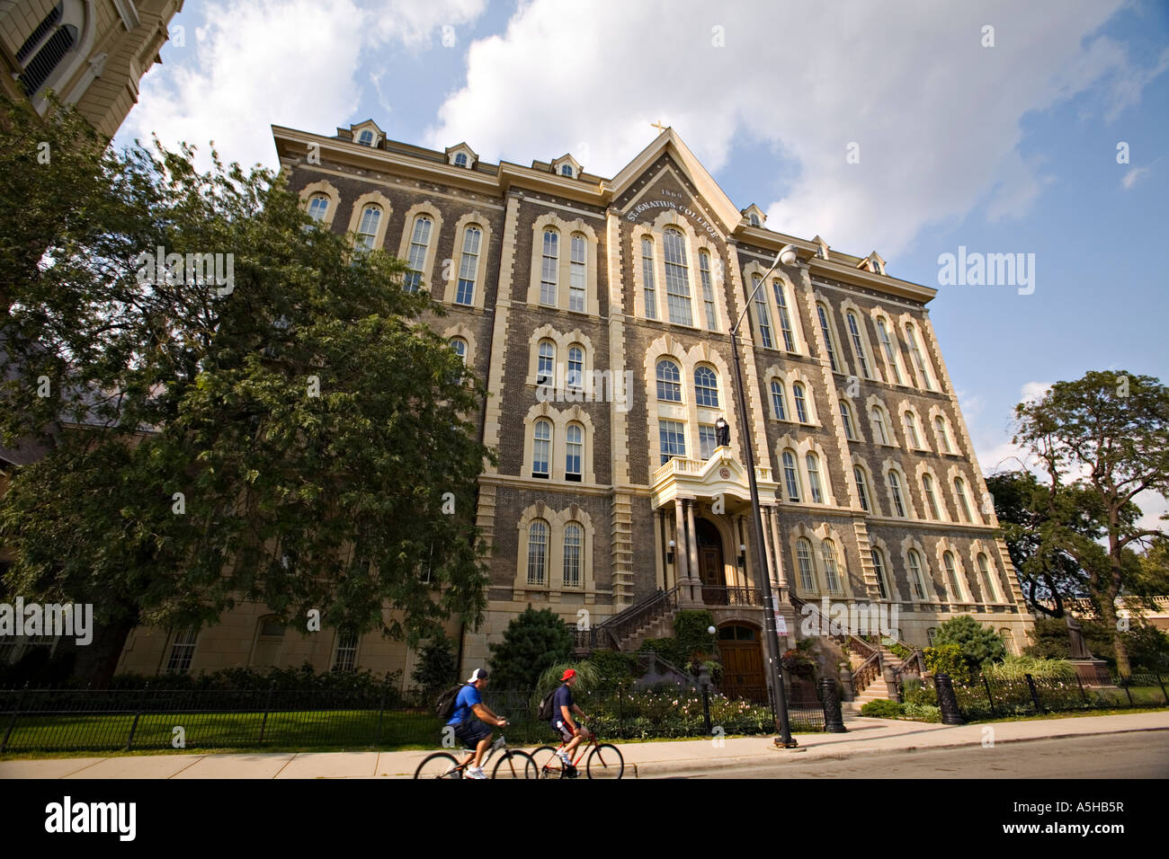 ILLINOIS Chicago Two boys ride bicycles past exterior of St Ignatius