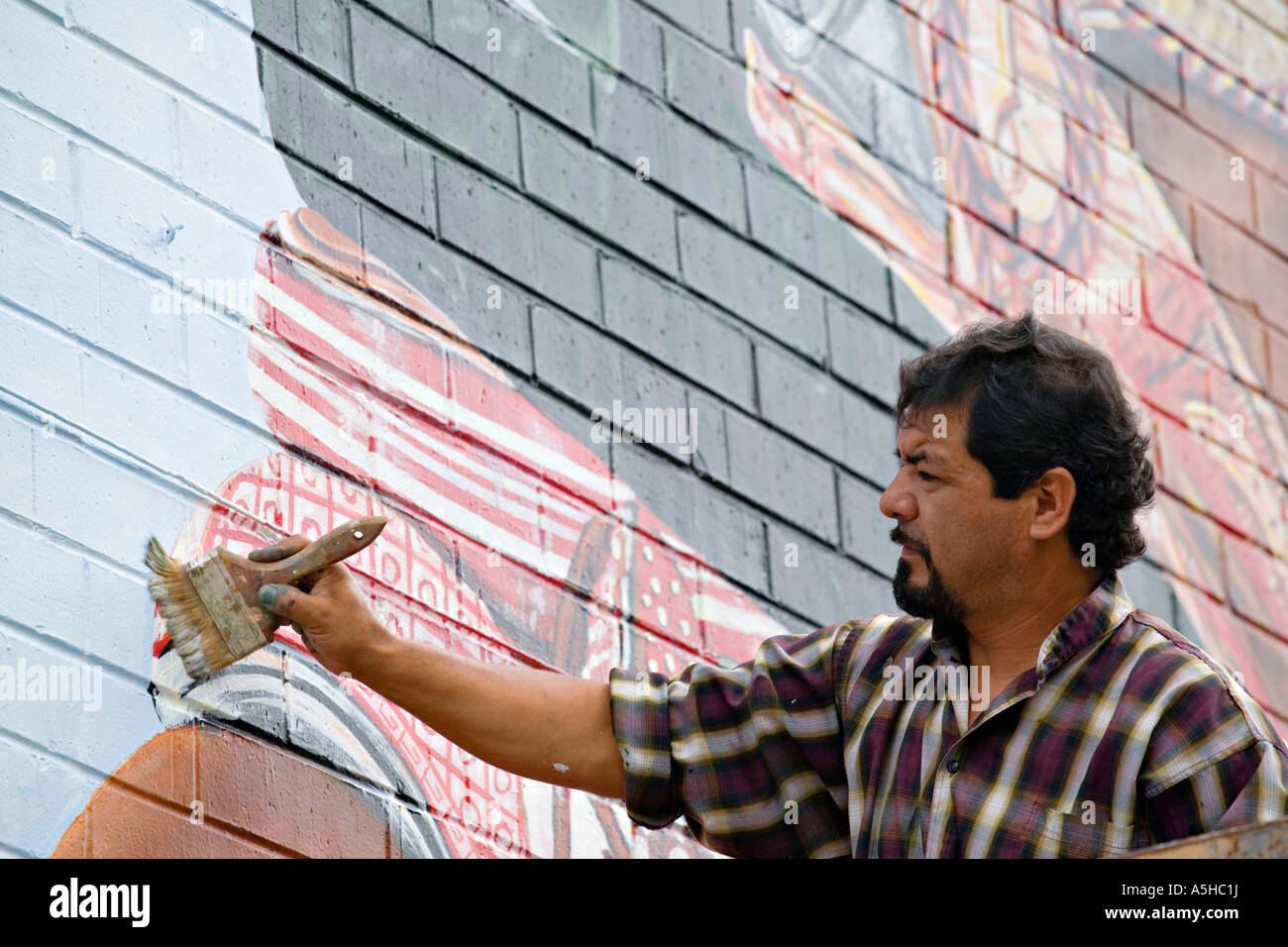 ILLINOIS Chicago Adult male paint outdoor mural using lift Pilsen