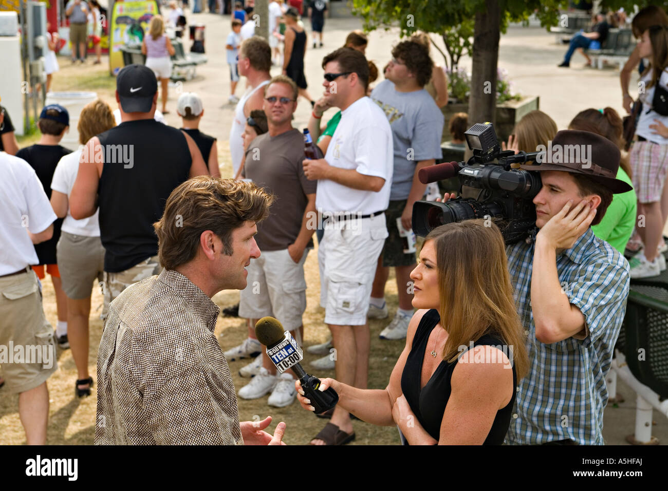 WISCONSIN Milwaukee Summerfest musical festival director interviewed by female reporter from local television station Stock Photo