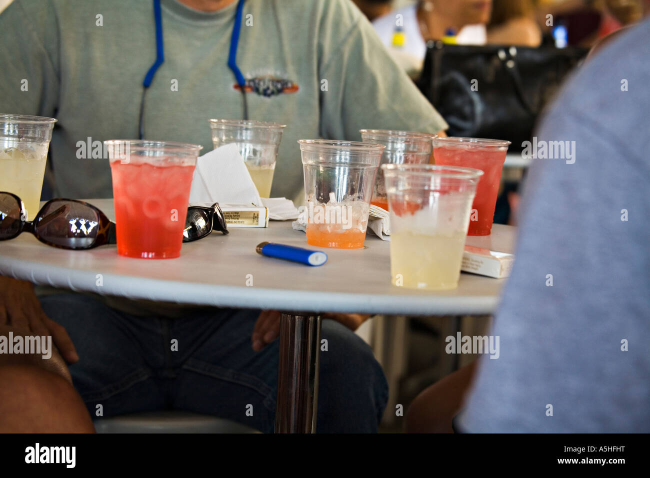 WISCONSIN Milwaukee Table with seven glasses of tropical alcoholic drinks and coctails cigarette lighter and package Summerfest Stock Photo