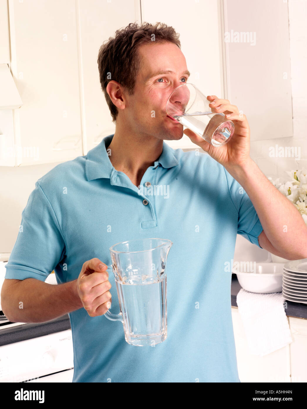 Man In Kitchen Drinking Glass Of Water Stock Photo 11317316 Alamy