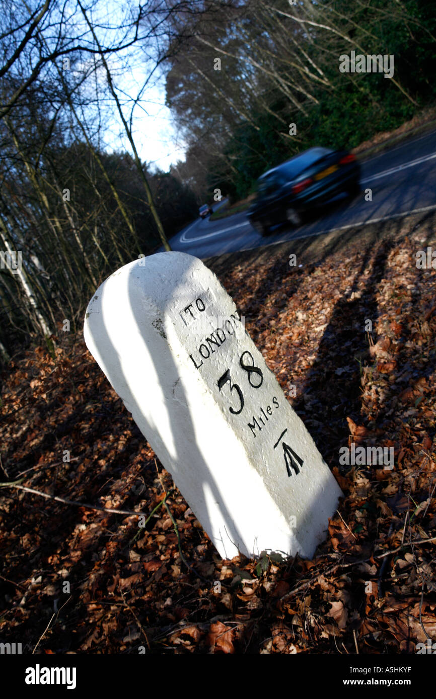 Old Milestone by the Roadside with distance to London marked Stock