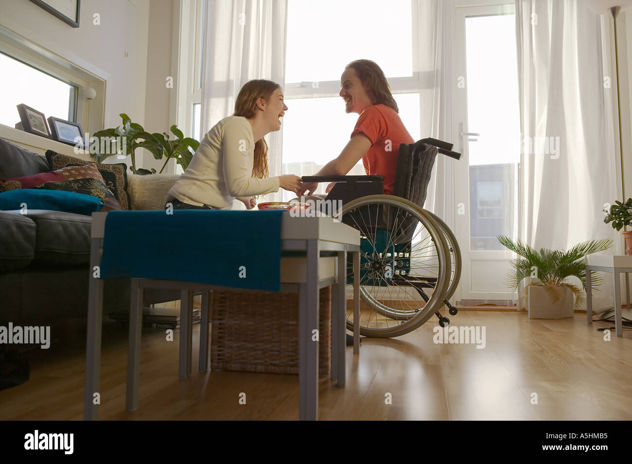Disabled man and partner in apartment Stock Photo Alamy