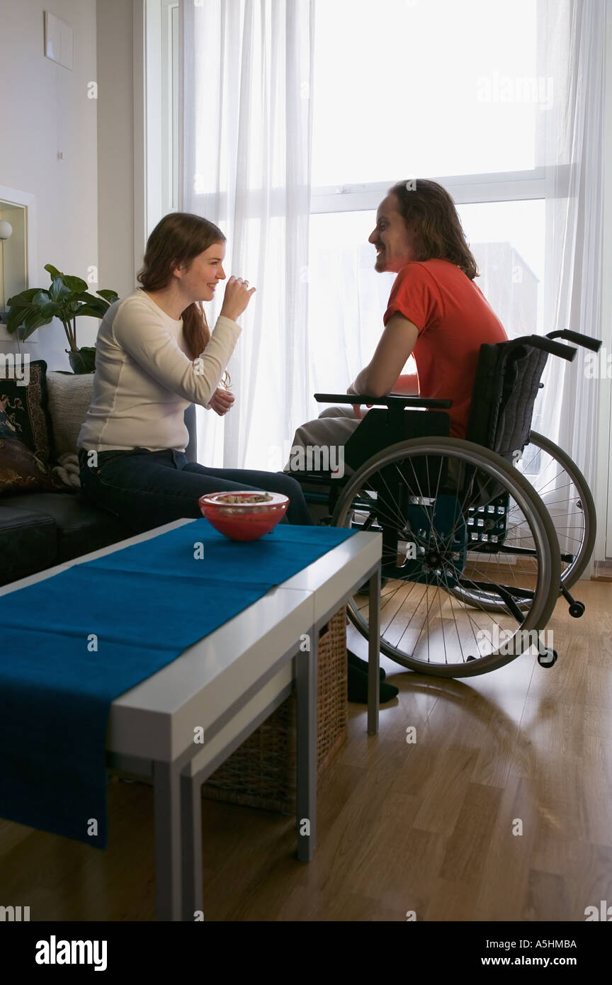 Disabled man and partner in apartment Stock Photo Alamy