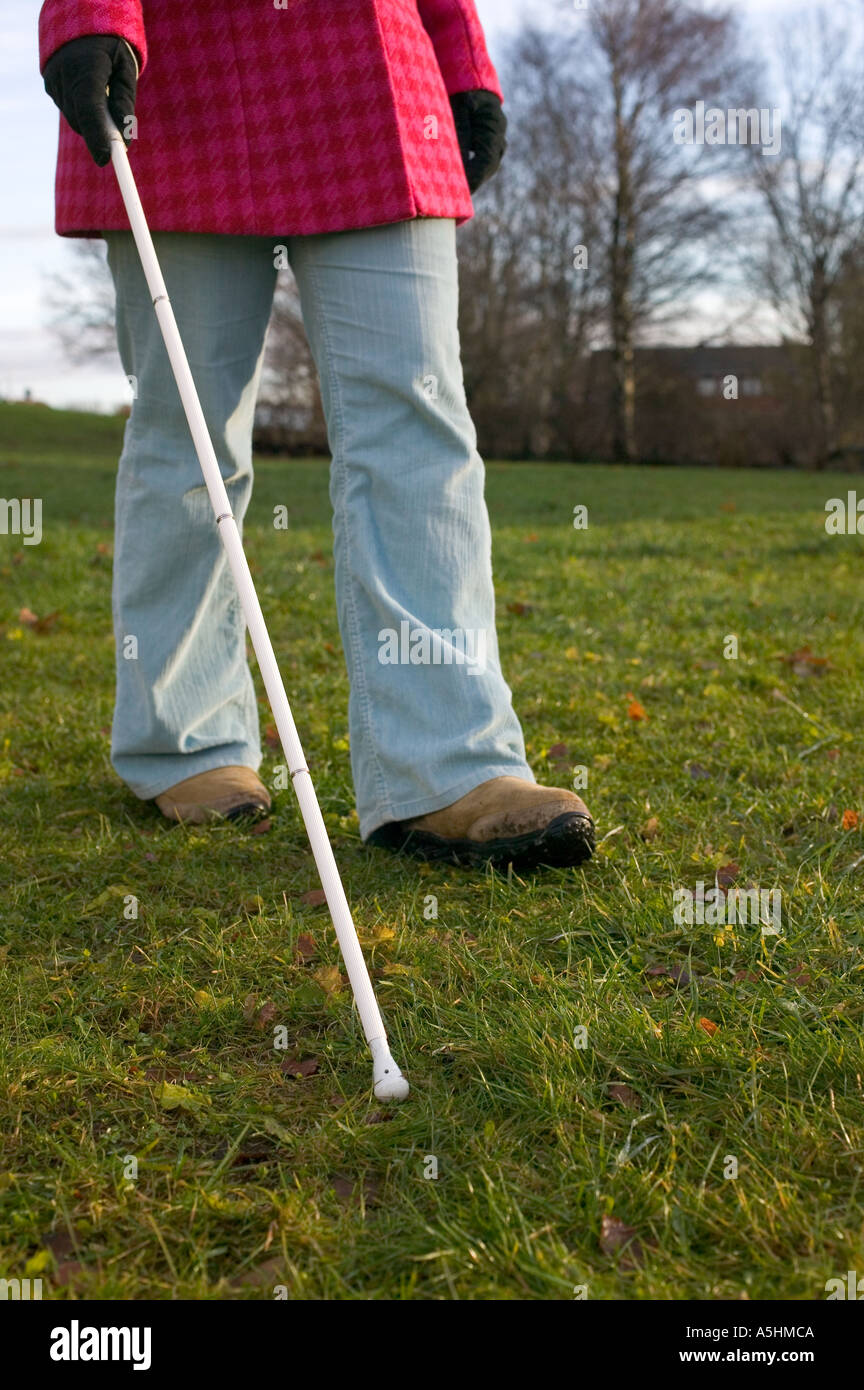 Blind woman using a cane Stock Photo