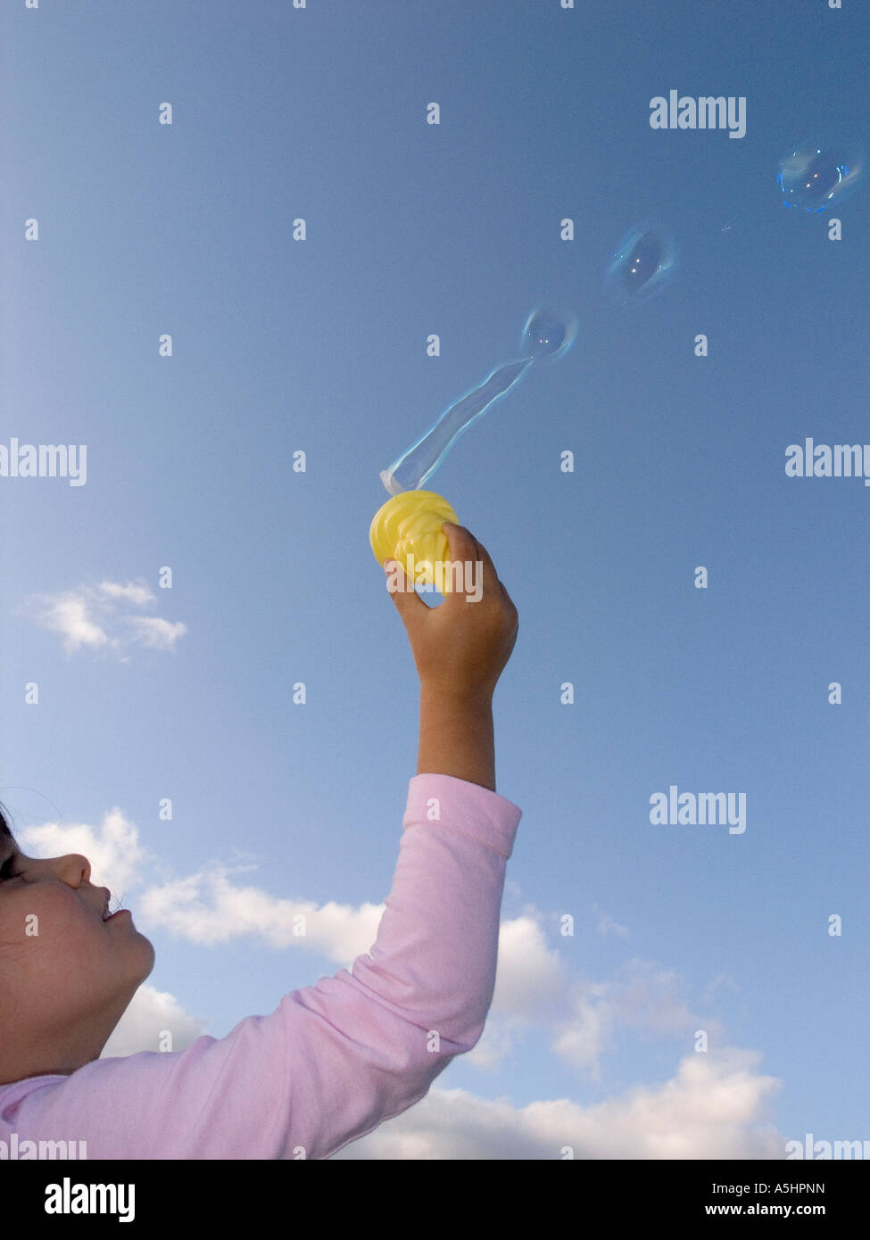 little girl playing with soap bubbles Stock Photo - Alamy