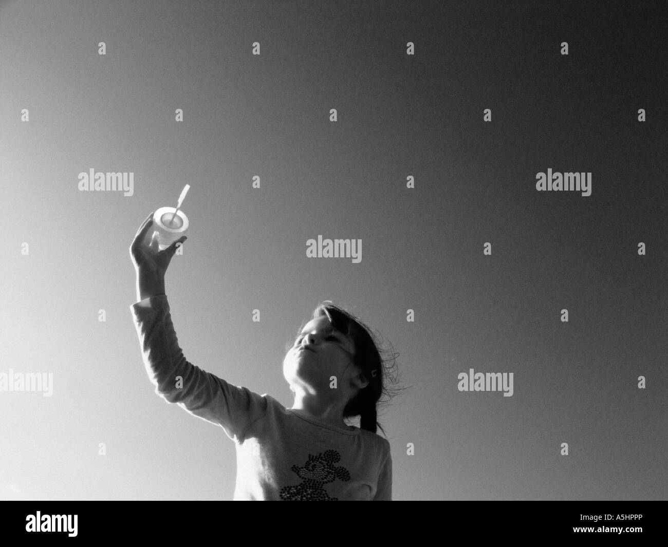 little girl playing with soap bubbles in the park Stock Photo - Alamy