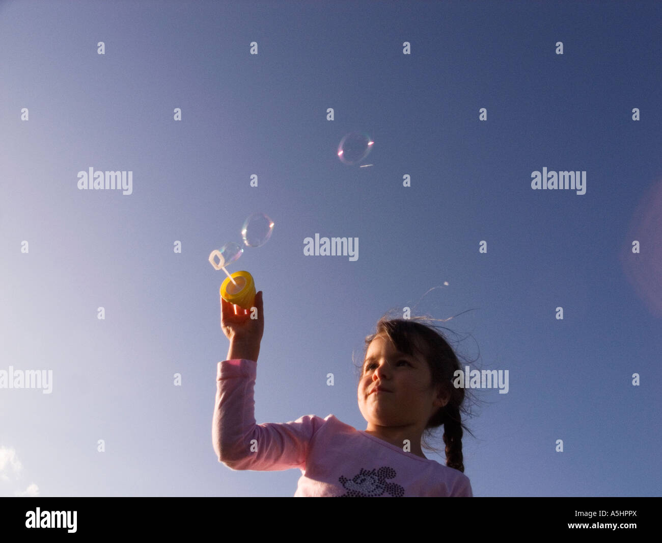 little girl playing with soap bubbles in the park Stock Photo - Alamy