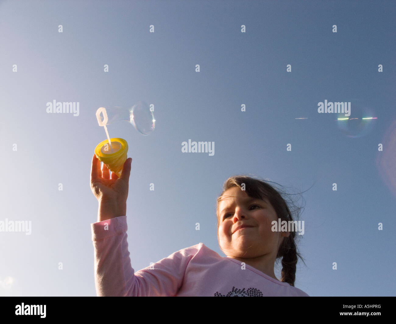 little girl playing with soap bubbles in the park Stock Photo - Alamy