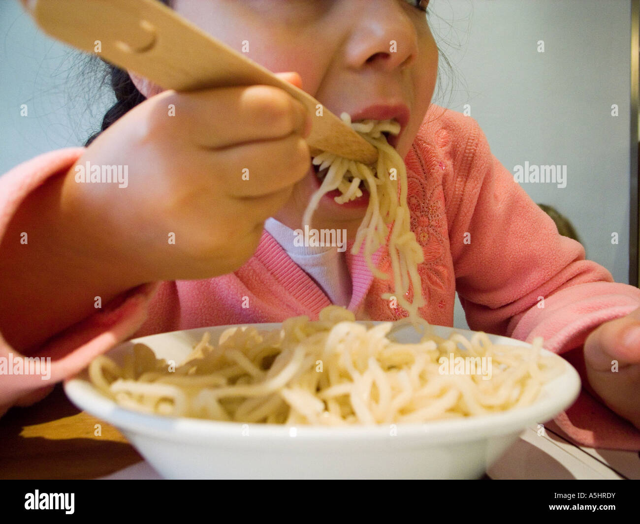 Child eating plain noodles Stock Photo - Alamy