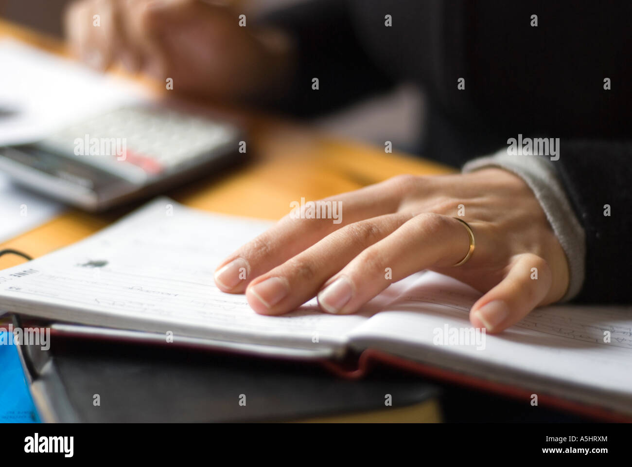 Self-employed person filling Tax return- adding up expenses Stock Photo