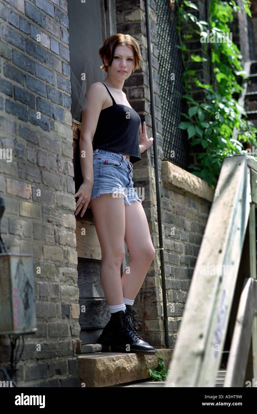 A young woman standing in an old doorway Stock Photo - Alamy