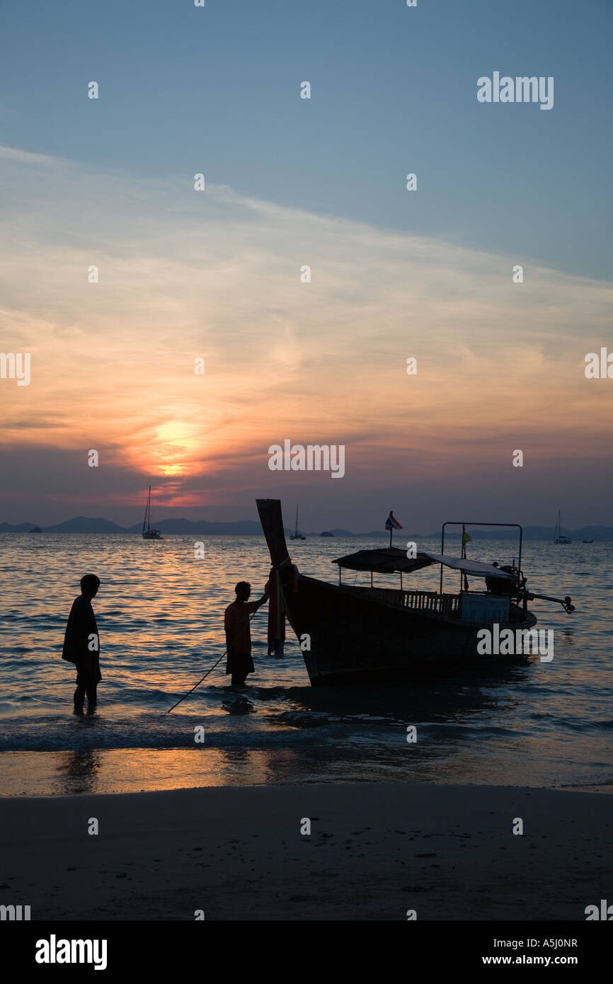 Long tail boats on Railay or Railey beach lagoon, Krabi Province Andaman Sea, Thailand, at sunset. Stock Photo