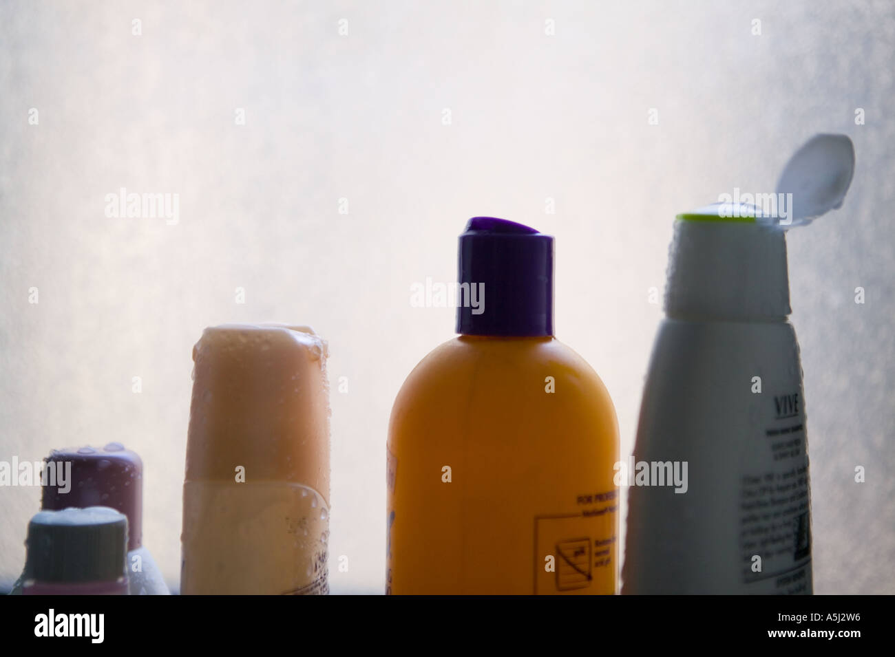 Plastic cosmetic bottles stand on a window sill February 2006 Stock Photo