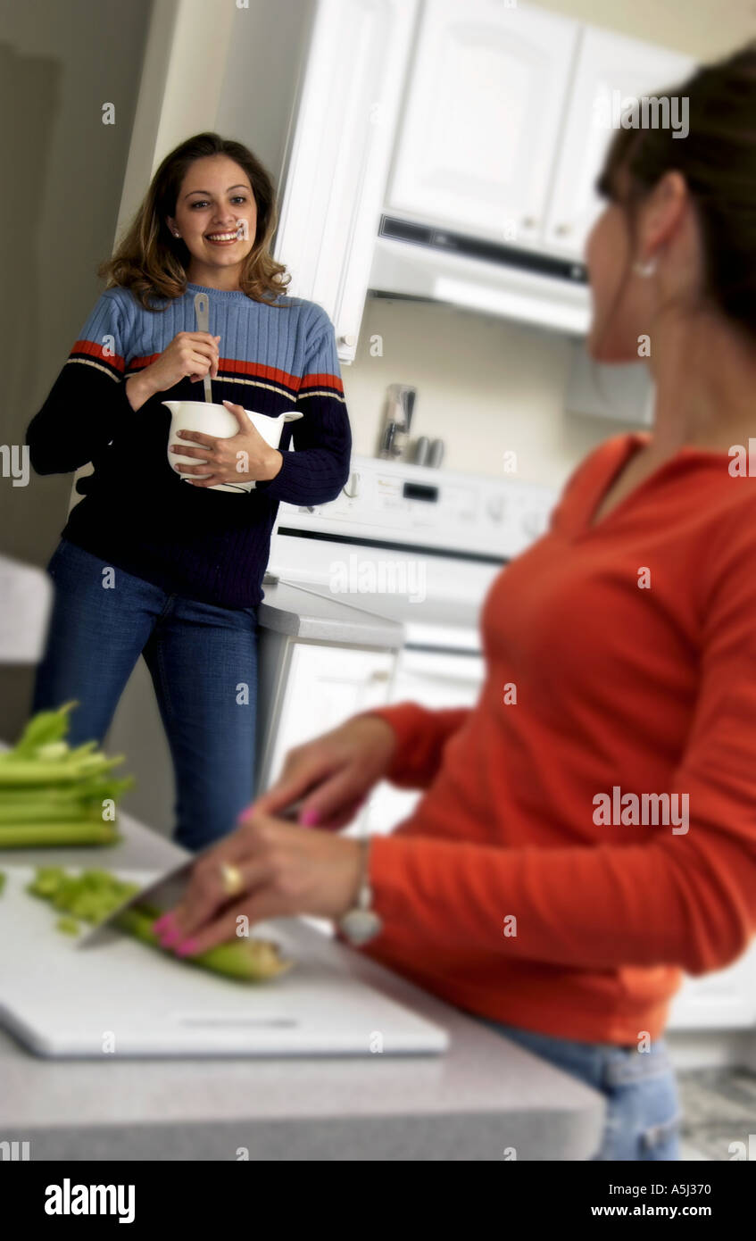 Two women cooking in the kitchen Stock Photo
