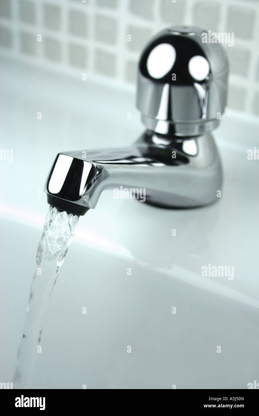 water running into sink from tap Stock Photo