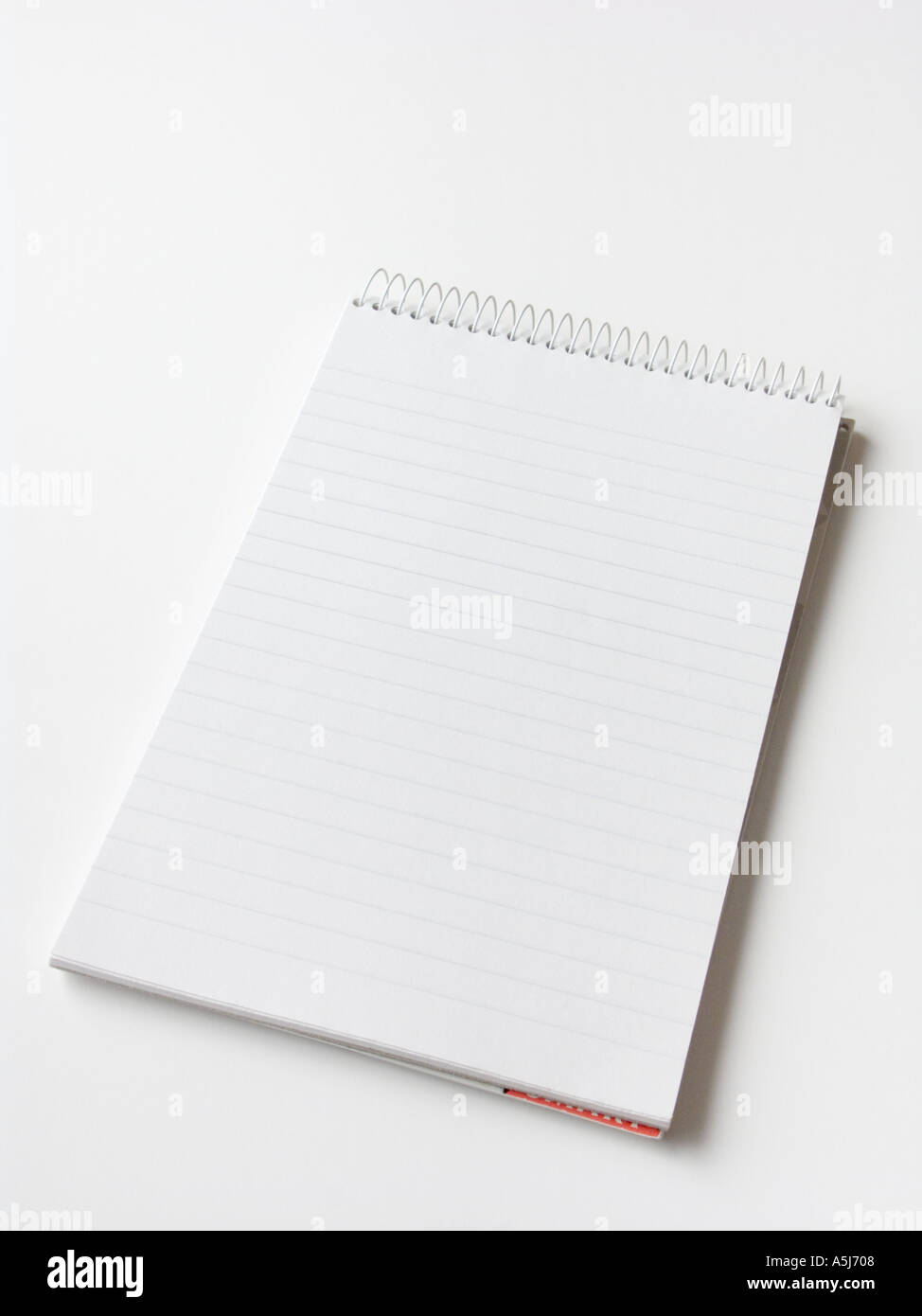 A spiral bound notepad on a plain white background Stock Photo