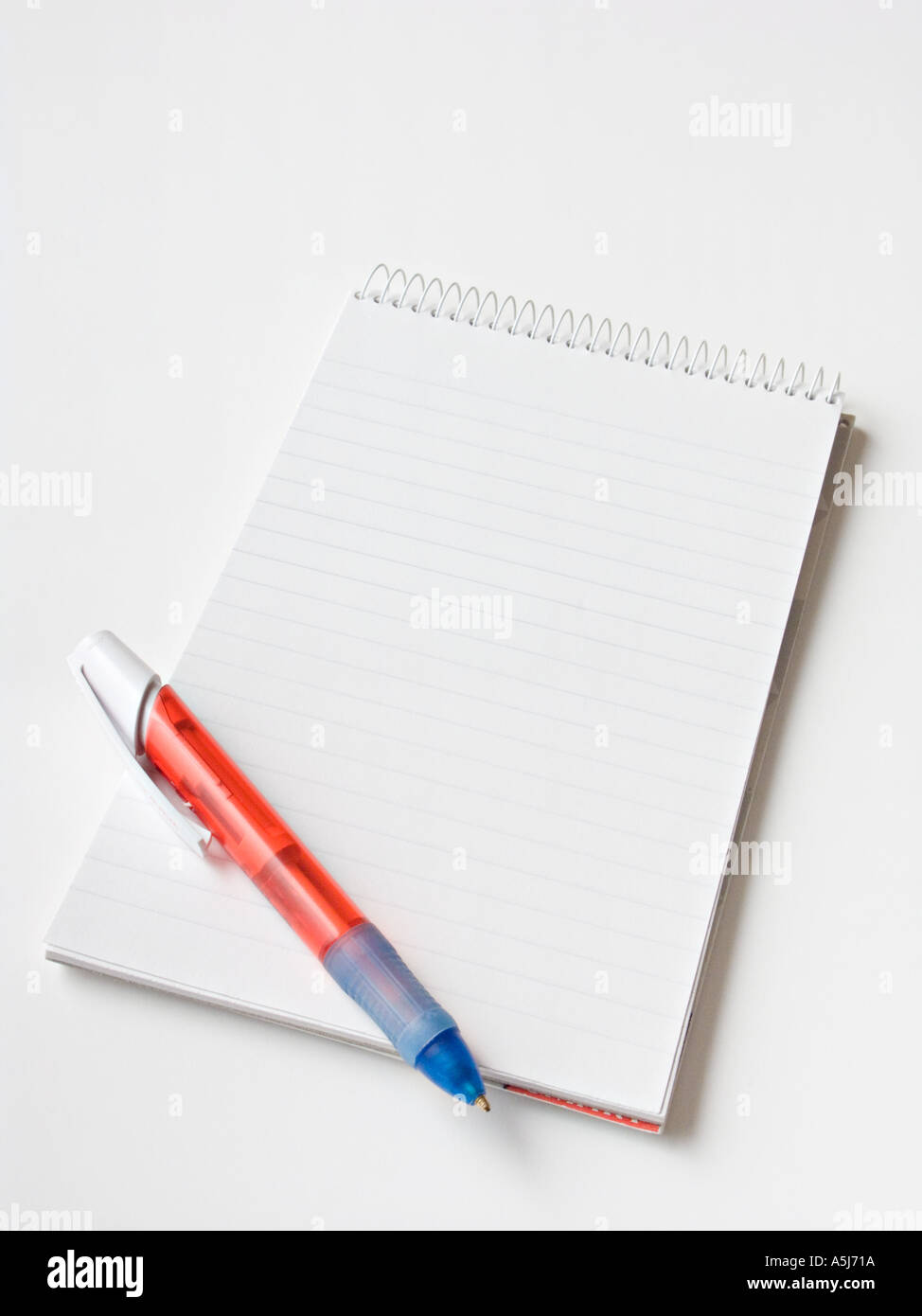 A Spiral Bound Notepad With A Red Pen On A Plain White Background Stock Photo Alamy