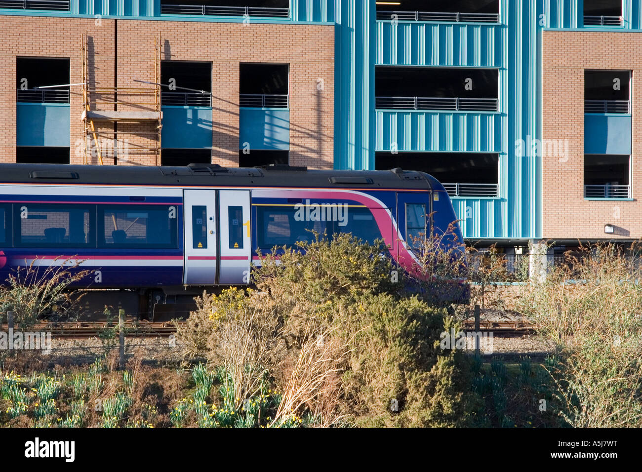 Diesel train stopped outside a commercial buildings near the railway