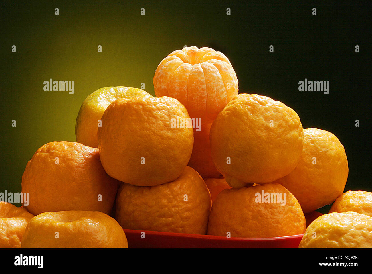 Fruit oranges in bowl on yellow black background Stock Photo