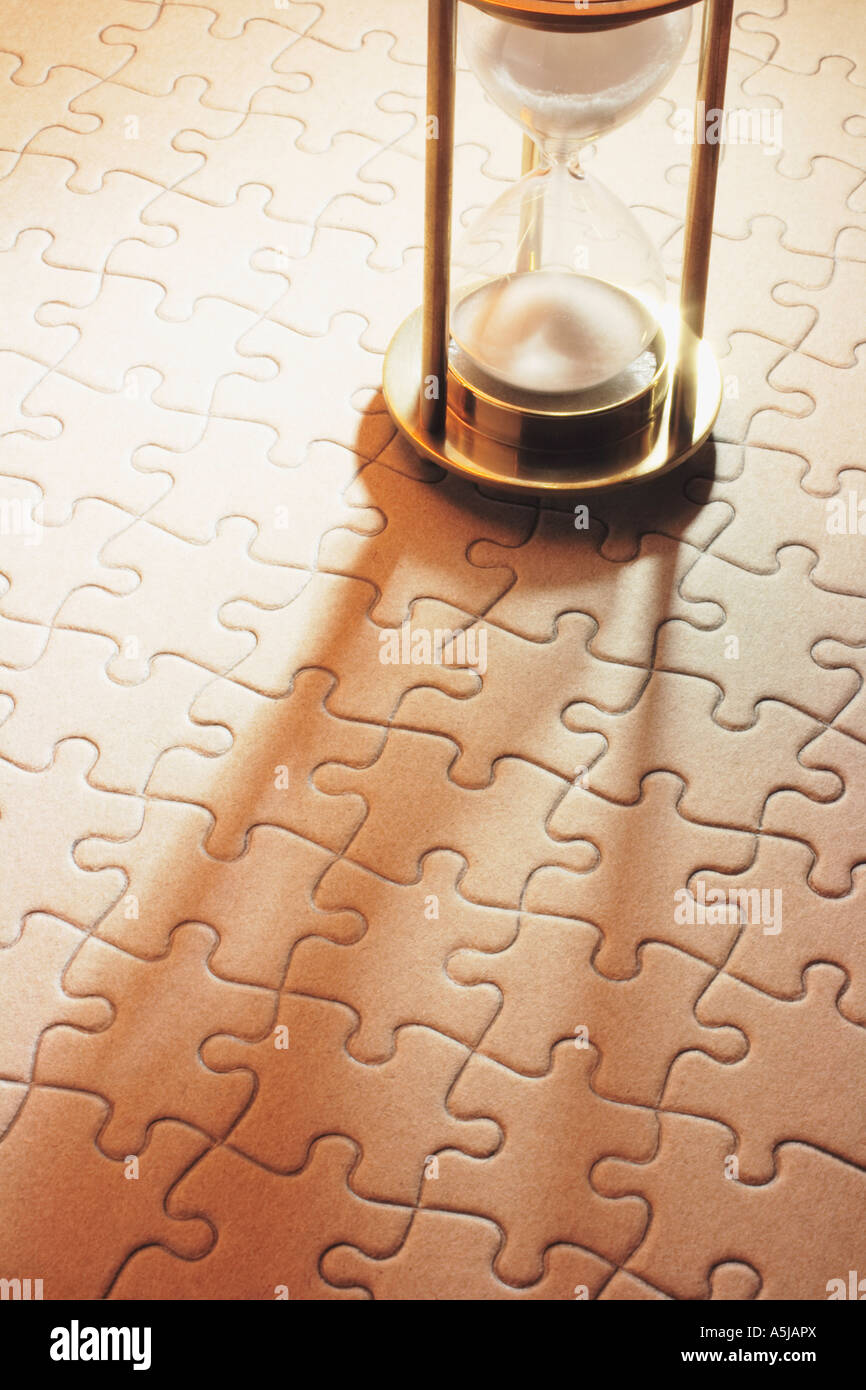 Hourglass on Jigsaw Puzzle Stock Photo