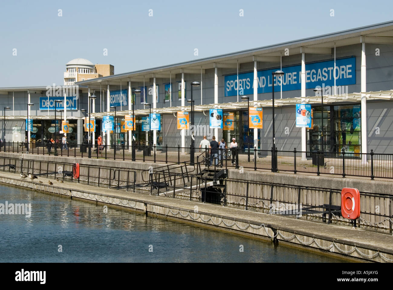 Decathlon retail business sports leisure shop store waterside location  pedestrian path note looped safety chains at waters edge Canada Water  London UK Stock Photo - Alamy