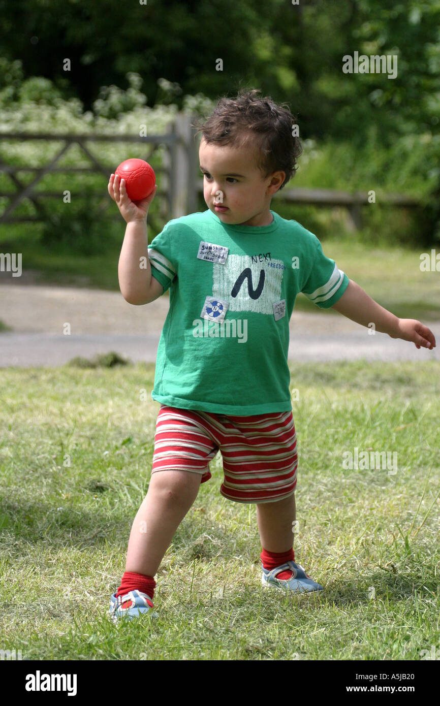 Small boy poised to throw a ball at a target Stock Photo Alamy