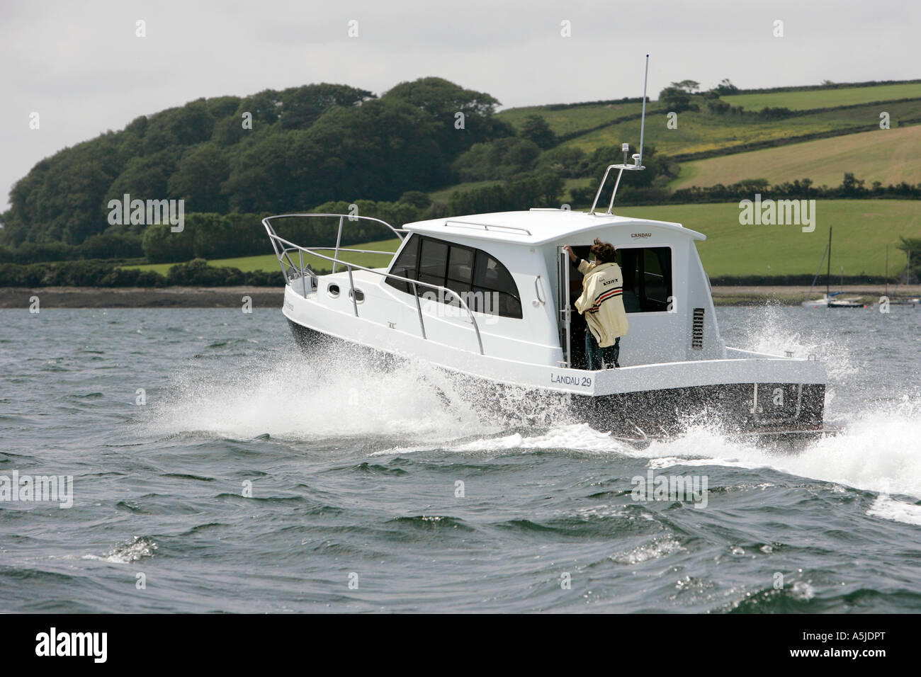 motor launch cruising in falmouth harbour uk Stock Photo Alamy