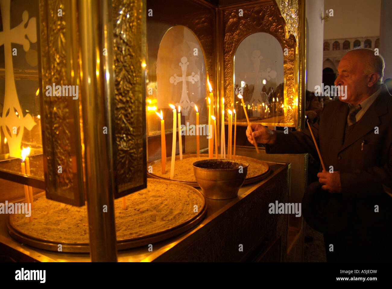 Man lighting a candle in a Greek Orthodox church Stock Photo Alamy