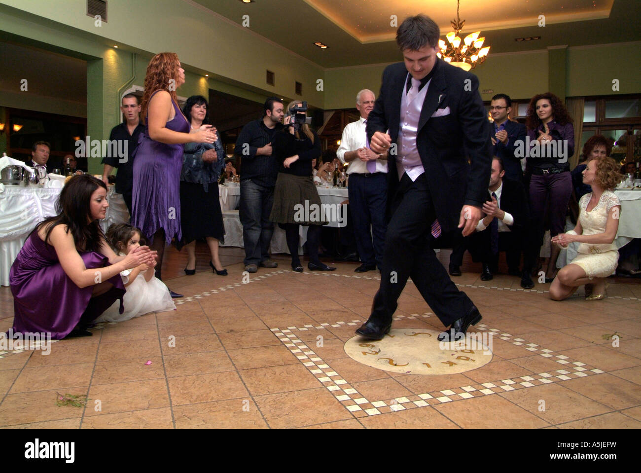 Best man dances solo at the wedding reception of a Greek wedding Stock Photo