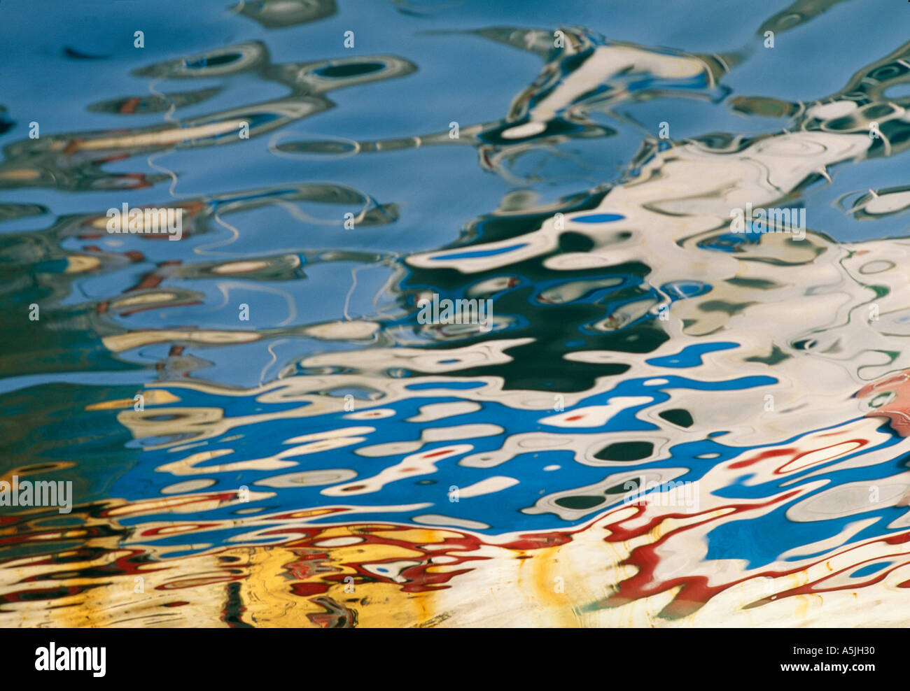 reflections of coloured boats in harbour water Stock Photo - Alamy