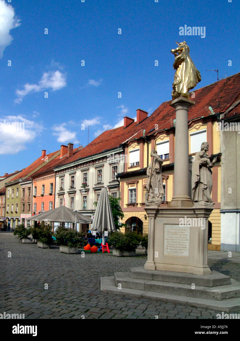 pillar with the virgin Mary and residential houses from 16th til 18th century at the place Lavni trg in Celje Slovenia Stock Photo
