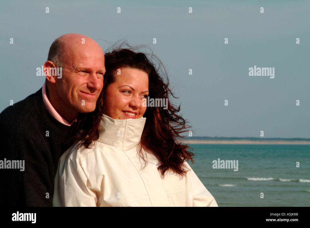 MR lovers walking at seacoast looking together ahead Stock Photo