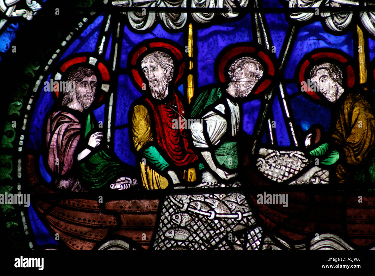 Medieval Stained glass window depicting the Apostles fishing. Miraculous Draught of Fishes, Poor Man's Bible window, Canterbury Cathedral Kent England Stock Photo