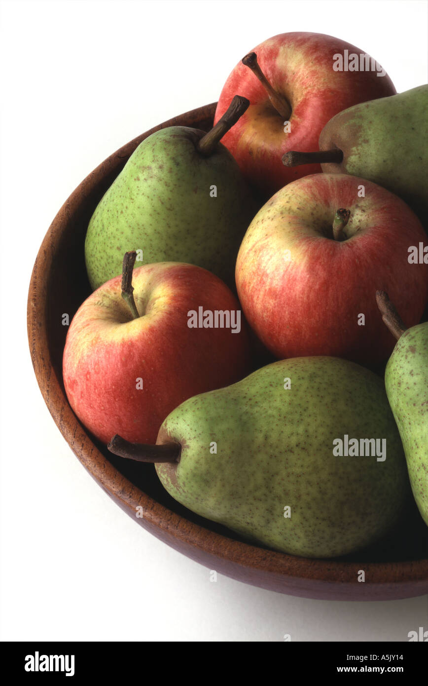Apples and pears in wooden bowl against white background Stock Photo