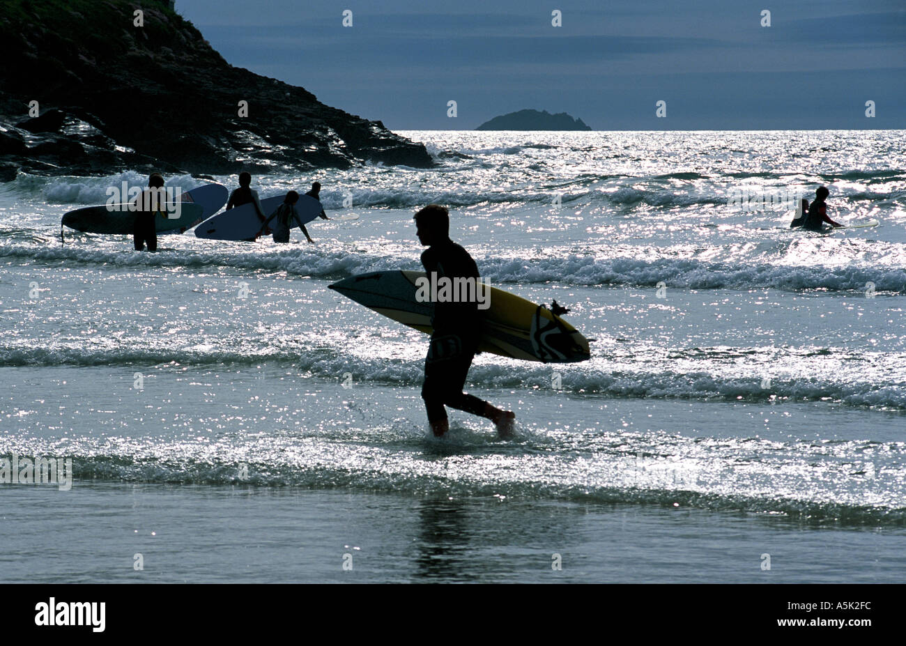 Playing in the surf Polzeath near Padstow Cornwall Great Britain Stock